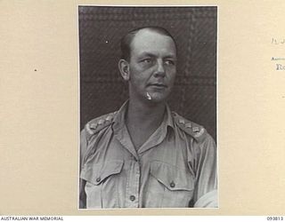 LAE AREA, NEW GUINEA, 1945-07-13. CAPTAIN M.H.M. ARNOTT, AIDE-DE-CAMP TO LIEUTENANT-GENERAL V.A.H. STURDEE, GENERAL OFFICER COMMANDING FIRST ARMY