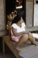 French Polynesia, women sitting on steps of home on Tahiti Island