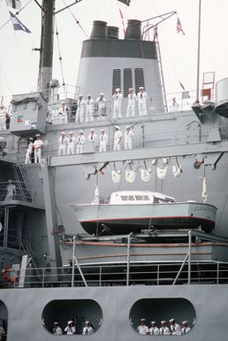 The crew of the combat stores ship USS NIAGARA FALLS (AFS 3) mans the rails upon the ship's arrival at Naval Station Guam