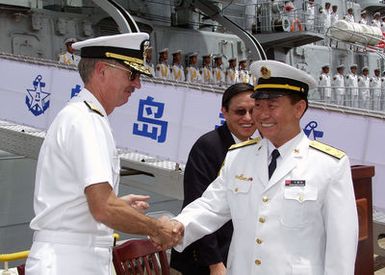 U.S. Navy Rear Adm. T. G. Alexander (left), Commander, Navy Region Hawaii, greets Chinese Peoples Liberation Army Navy Rear Adm. Wang Fushan, Deputy Commander, North Sea Fleet, following the arrival of two Chinese ships, the Luhu Class (Type 052) Guided Missile Destroyer QINGDAO (DDG 113) and the Fuquing Class Replenishment Ship HONGZEHU (AOR 881) at Naval Station Pearl Harbor, Hawaii, for a Goodwill Visit on Sept. 6, 2006. The visit provides an excellent opportunity to enhance cooperation between the two navies and underscores the United States commitment to supporting ongoing cooperative efforts in the Pacific Region. (U.S. Navy photo by CHIEF Mass Communication SPECIALIST David Rush)...