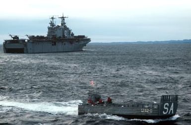 An LCM 6 mechanized landing craft heads towards shore after exiting from the well deck of the amphibious assault ship USS SAIPAN (LHA 2) during NATO Exercise NORTHERN WEDDING '86