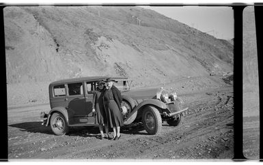 Nell and Helen Hare standing beside Auburn car