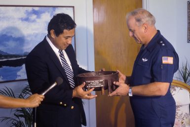 Major General (MGEN) Donald D. Brown, commander, 22nd Air Force, exchanges gifts with Samoan Lieutenant Governor Eni Hunkin. Brown is visiting Samoa after a 22nd Military Airlift Squadron aircraft delivered an emergency electrical generator and equipment to Pago Pago