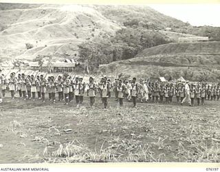 NADZAB, NEW GUINEA. 1944-09-26. VX13 LIEUTENANT GENERAL S.G. SAVIGE CB, CBE, DSO, MC, ED, GOC NEW GUINEA FORCE (1), INSPECTING B COMPANY, 1ST NEW GUINEA INFANTRY BATTALION AT CAMP DIDDY