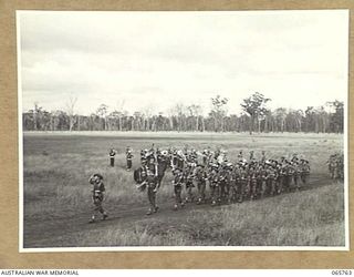 WONDECLA, QLD. 1944-04-15. HEADQUARTERS COMPANY, 2/1ST INFANTRY BATTALION GIVE "EYES RIGHT" AS THEY MARCH PAST THEIR COMMANDING OFFICER, NX163 LIEUTENANT COLONEL P.A. CULLEN, DSO. (1), WITH THE ..