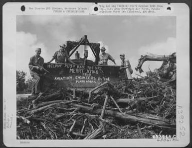 Aviation Engineers Who Are Clearing Debris From Area On Saipan, Marianas Islands, Pause Long Enough To Wish The Folks At Home A 'Merry Christmas'. They Are, Left Ot Right: T/4 Charles Fischer, Pfc. William K. Visner, T/5 Dale Peterson, And Cpl. Angelo Del (U.S. Air Force Number 65361AC)