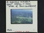 [Aerial view of] a highland airstrip, government station and first phase of town development, [Papua New Guinea], 1963