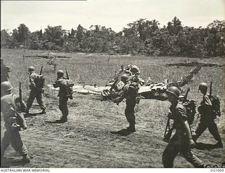 AITAPE, NORTH EAST NEW GUINEA. 1944-05-02. US TROOPS MARCH PAST A WRECKED JAPANESE FIGHTER AIRCRAFT AS THEY GO FORWARD ON PATROL. MEMBERS OF THIS AMERICAN UNIT LED RAAF ENGINEERS INTO AITAPE DURING ..