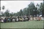 Dancers with shields and spears, with women dancers to the right