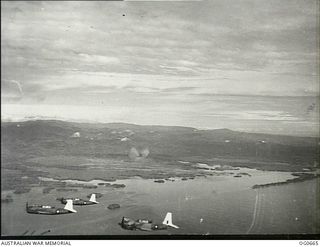 ALEXISHAFEN, NEW GUINEA. 1944-02-27. IN FLIGHT, VULTEE VENGEANCE DIVE BOMBER AIRCRAFT OF NO. 24 SQUADRON RAAF FORM UP AND TURN FOR HOME AFTER AN AIR RAID ON THE JAPANESE-HELD AIRSTRIP AT ..