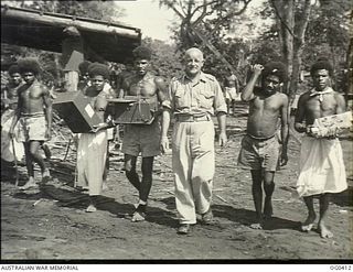 VIVIGANI, GOODENOUGH ISLAND, PAPUA. 1943-12-22. "MAJOR" BIRT, SALVATION ARMY REPRESENTATIVE WITH THE RAAF AT AN ADVANCED OPERATIONAL BASE LEAVING A RAAF SAWMILL AFTER ENTERTAINING THE "STAFF" WITH ..