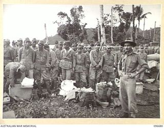 KAIRIRU ISLAND, NEW GUINEA. 1945-09-17. CAPTAIN J.O. MOULDEN, GENERAL STAFF OFFICER 3 INTELLIGENCE HEADQUARTERS 6 DIVISION SUPERVISING JAPANESE NAVAL PERSONNEL WHO WAS WAITING TO BOARD BARGES FOR ..