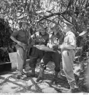 FINSCHHAFEN, NEW GUINEA. 1943-10-25. NX8 LIEUTENANT GENERAL SIR LESLIE MORSHEAD KCB KBE CMG DSO ED, GENERAL OFFICER COMMANDING 2ND AUSTRALIAN CORPS, DISCUSSING MATTERS WITH SENIOR OFFICERS AT ..