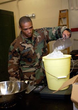 U.S. Air Force 36th Medical Support Squadron, 36th Air Expeditionary Wing STAFF SGT. Kenrick McClain weighs ice during exercise Beverly Bearcat at Andersen Air Force Base, Guam, on Dec. 3, 2004.(U.S. Air Force PHOTO by AIRMAN First Class Kristin Ruleau) (Released)