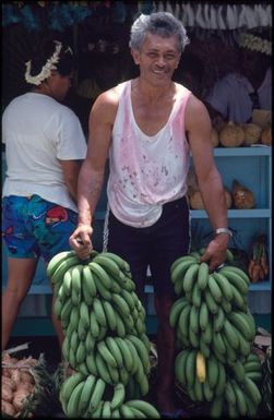 Man carrying banana bunches