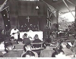 RABAUL, NEW BRITAIN, 1945-12-25. THE RECTOR CONDUCTING THE CHRISTMAS SERVICE IN ST ALBAN'S CHURCH OF ENGLAND, HEADQUARTERS 11 DIVISION