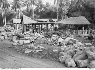 MILNE BAY, PAPUA. 1942-09. PICTURE SHOWING THE DAMAGE TO THE MILNE BAY FORCES CANTEEN WHEN IT WAS BLOWN UP BY LIEUTENANT W.J. CROFTS, ROYAL AUSTRALIAN ENGINEERS, DURING AN ATTACK BY THE JAPANESE