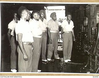 NEWCASTLE, NSW. 1944-01-28. AUSTRALIAN AND NEW GUINEA ADMINISTRATION UNIT NATIVES INSPECTING THE BROKEN HILL PTY., STEEL ROLLING MILLS