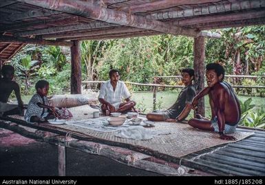 Lunch at Pwanapwana served under Pastor Fred's house. Sebastian in white shirt, centre