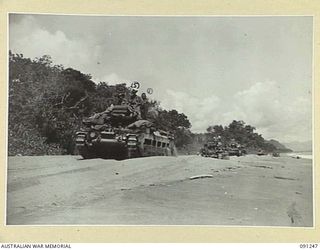 KOFI VILLAGE, NEW GUINEA. 1945-04-21. MATILDA TANKS OF C SQUADRON, 2/4 ARMOURED REGIMENT, RUMBLE ALONG THE BEACH AT KOFI VILLAGE EN ROUTE FOR KARAWOP PLANTATION WHERE THEY WILL CONTINUE THEIR ROLE ..