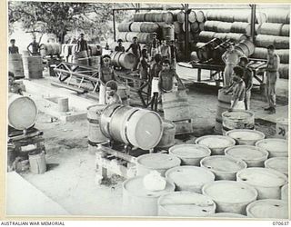 PORT MORESBY, PAPUA. 1944-02-26. THE DRUM-RUMBLING PLANT, WHICH IS A SECTION OF THE BULK OIL INSTALLATION, 1ST PETROLEUM STORAGE COMPANY