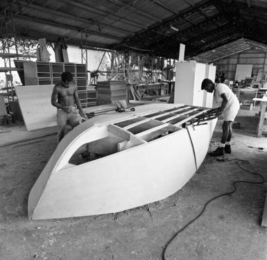 Two men constructing a boat at Briggs MacLean, Madang Province, Papua New Guinea, approximately 1968 / Robin Smith