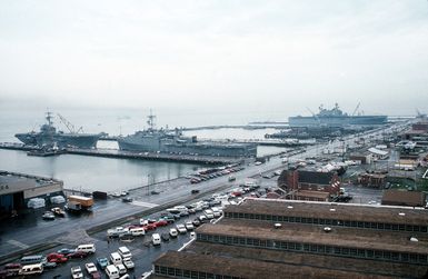 The amphibious assault ship USS INCHON (LPH-12), left, the amphibious transport dock USS PONCE (LPD-15), center, and the amphibious assault ship USS SAIPAN (LHA-2) lie tied up at the naval station