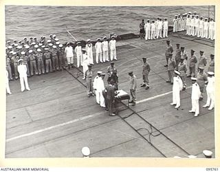 AT SEA OFF RABAUL, NEW BRITAIN. 1945-09-06. THE SURRENDER CEREMONY ON BOARD THE AIRCRAFT CARRIER HMS GLORY, SHOWING GENERAL H. IMAMURA, COMMANDER EIGHTH AREA ARMY, SIGNING THE INSTRUMENT OF ..