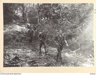 BOUGAINVILLE, 1945-06-07. A PATROL FROM 2/8 COMMANDO SQUADRON, SETTING OUT ALONG THE TRACK TO HARASS THE ENEMY AND GAIN INFORMATION AHEAD OF THE ADVANCING INFANTRY. PATROLS TRAVEL LIGHT CARRYING ..