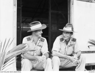 MADANG, NEW GUINEA. C. 1944-10. SENIOR OFFICERS AT A FORWARD RAAF BASE IN NEW GUINEA ARE GROUP CAPTAIN (GP CAPT) L. V. LACHAL, MELBOURNE, VIC (RIGHT), AND GP CAPT A. D. CHARLTON, MELBOURNE, VIC