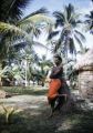 Fiji, man leaning against palm in Yasawa Islands