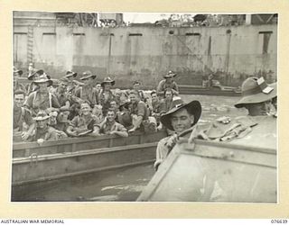 LAE, NEW GUINEA. 1944-11-02. TROOPS OF A COMPANY, 14/32ND INFANTRY BATTALION ON THEIR WAY OUT TO THE TROOPSHIP, "CAPE ALEXANDER" IN AUSTRALIAN ARMY AMPHIBIOUS LOAD CARRIER