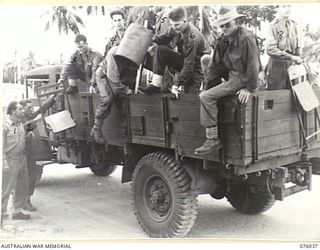 MADANG, NEW GUINEA. 1944-09-16. THE EARLY CROWD ARRIVING AT THE TEMPORARY STADIUM WAITING FOR THE COMMENCEMENT OF THE BOXING AND WRESTLING COMPETITIONS TO START BETWEEN TEAMS FROM THE RAN, AMF AND ..