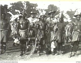 MALAHANG, LAE, NEW GUINEA. 1944-12-25. AUSTRALIAN TROOPS WITH FINSCHHAFEN NATIVES AT THE SING-SING HELD IN THE AUSTRALIAN NEW GUINEA ADMINISTRATIVE UNIT NATIVE COMPOUND