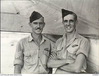 PORT MORESBY, PAPUA. C. 1943-07. FLIGHT SERGEANT HAROLD TAPNER, WARATAH, NSW (LEFT) AND HIS OBSERVER WARRANT OFFICER ROBERT THOMAS, EAST MALVERN, VIC, OF NO. 30 (BEAUFIGHTER) SQUADRON RAAF AFTER ..