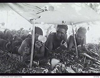 BUNABUN, NEW GUINEA. 1944-05-28. MEMBERS OF 35TH INFANTRY BATTALION RESTING IN A TWO-MAN TENT DURING A PAUSE IN THE DRIVE TOWARDS WEWAK. LEFT TO RIGHT: NX120680 PRIVATE J. BUTLER; NX120692 PRIVATE ..