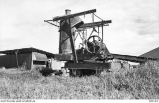 LAE, NEW GUINEA. 1945-11-26. THE GUINEA AIRWAYS OLD STEAM CRANE. IT WAS WRECKED BY THE NEW GUINEA VOLUNTEER RIFLES BEFORE THE EVACUATION OF LAE. 33 SQUADRON, RAAF, NOW OCCUPY THE AREA