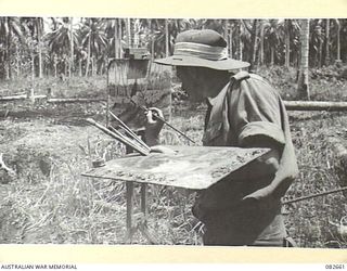 MILILAT, NEW GUINEA.1944-10-12. AN ARTIST AT HQ 4 ARMOURED BRIGADE WORKING ON THE PAINTING OF A BOGGED TANK