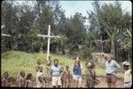 Ery Ben, dressed in leaves and mud, clowns with local children and visitors