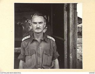 CAPE WOM, WEWAK AREA, NEW GUINEA. 1945-08-07. LIEUTENANT COLONEL J. TALBOT, COMMANDER, AUSTRALIAN ARMY SERVICE CORPS, 6 DIVISION AT HEADQUARTERS COMMAND AUSTRALIAN ARMY SERVICE CORPS, 6 DIVISION