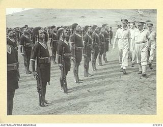 BISIATABU, NEW GUINEA. 1944-04-19. MAJOR GENERAL B.M. MORRIS, DSO, GENERAL OFFICER COMMANDING AUSTRALIAN NEW GUINEA ADMINISTRATIVE UNIT (3), DURING AN INSPECTION OF THE ROYAL PAPUAN CONSTABULARY AT ..