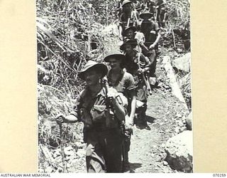 FARIA VALLEY, NEW GUINEA, 1944-02-09. 2/10TH INFANTRY BATTALION MEMBERS WORKING DOWN THE FARIA VALLEY TOWARDS GUY'S POST. THEY ARE PROCEEDING TO POSITIONS IN THE RAMU VALLEY VACATED BY THE 58/59TH ..