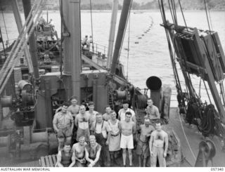 Members of the crew aboard the SS Mernoo Marine Cable Laying Ship. Identified are: front three men squatting are firemen/stokers;  Harry Packer, Foreman (centre, wearing overalls); Roy Cameron ..