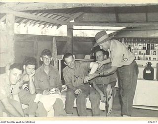 LAE, NEW GUINEA. 1944-09-28. VX104118 MAJOR R.C. UPSON, COMMANDING OFFICER, 22ND WORKS COMPANY, ROYAL AUSTRALIAN ENGINEERS (6), MAKING A PERSONAL INSPECTION AT THE REGIMENTAL AID POST. IDENTIFIED ..