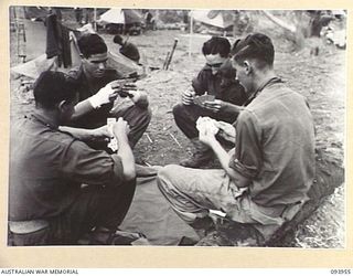 ULUPU, NEW GUINEA, 1945-07-10. MEMBERS OF 16 PLATOON, D COMPANY, 2/5 INFANTRY BATTALION, PLAYING CARDS. THE MEN ARE HAVING TWO DAYS' REST AFTER THEIR SUCCESS IN DESTROYING THE JAPANESE POSITION ON ..