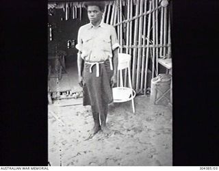 ORO BAY, NEW GUINEA. 1943. NAVY OFFICE STAFF. MOSES, THE NATIVE COOK. (NAVAL HISTORICAL COLLECTION)