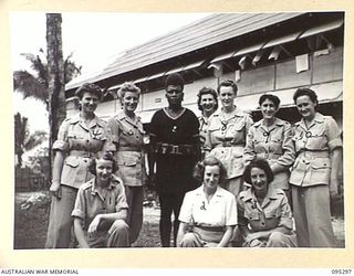 PALMALMAL PLANTATION, JACQUINOT BAY, NEW BRITAIN, 1945-08-14. A GROUP OF AUSTRALIAN ARMY MEDICAL WOMEN'S SERVICE MEMBERS OF THE 2/8 GENERAL HOSPITAL WITH A CONSTABLE OF THE ROYAL PAPUAN ..