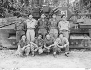 Group portrait of personnel on No. 9 Troop, B Squadron, 2/4th Armoured Regiment. Left to right, back row: NX174506 Trooper (Tpr) N O'Neill of Cessnock, NSW; SX14615 Corporal C R Hockey MM of ..