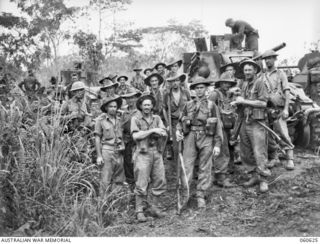 SATTELBERG AREA, NEW GUINEA. 1943-11-18. TROOPS OF A COMPANY, 2/48TH AUSTRALIAN INFANTRY BATTALION REGROUPING IN PREPARATION FOR ANOTHER ATTACK ON SATTELBERG. SHOWN ARE: SX16704 PRIVATE A. R. ..