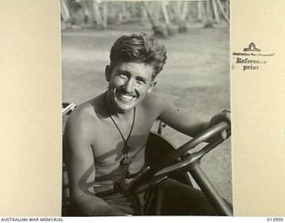 1942-12-05. BUNA, PAPUA. THIS CHEERFUL JEEP DRIVER IS GUNNER ROY MILSTEAD OF COONAMBLE, NSW